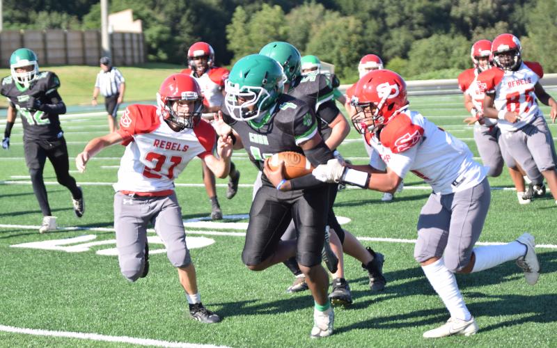Eighth grader Kendaus Burtch runs through would-be Stephens County tacklers in the Franklin County Middle School Cubs’ season opening win Thursday at Jeff Davis Field at Ed Bryant Stadium. (Photo by Scoggins)