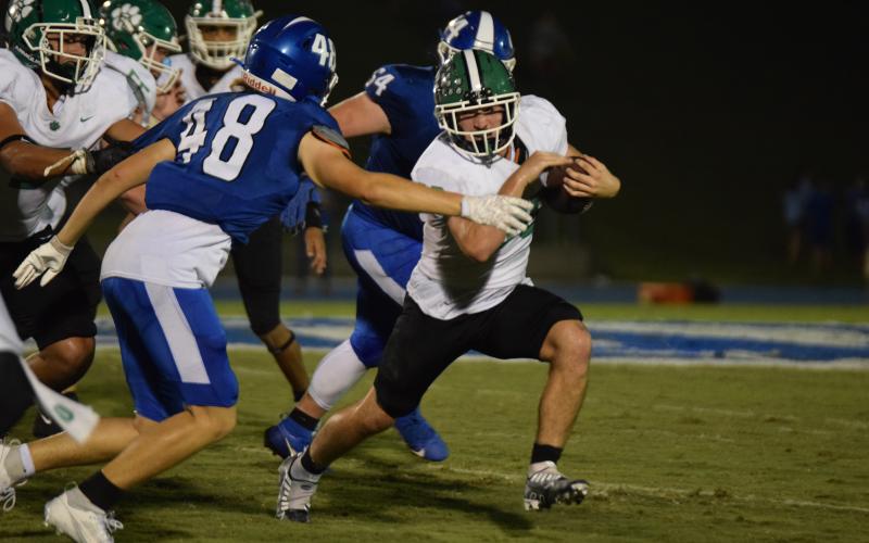 Senior Brady Simms runs past a Banks County defender during Friday night’s game in Homer. Simms finished with 221 yards rushing for the Lions. (Photo by Scoggins)