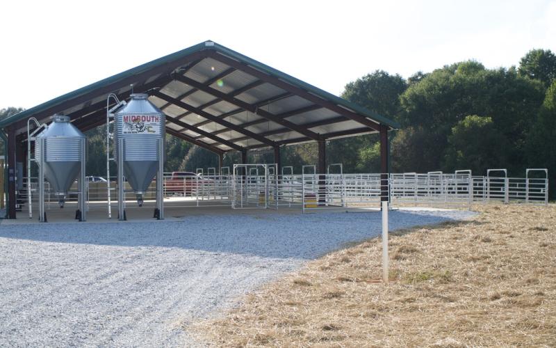 The large animal barn includes cattle pens with attached runs and a practice arena.