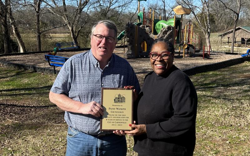 Now former Mayor Harris Little presents Patsy Watkins with a plaque to commemorate her eight years of service on the Carnesville City Council.
