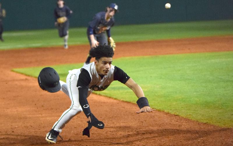 Kain Roach dives into third base after serving as a courtesy runner against Apalachee. (Photo by Scoggins)