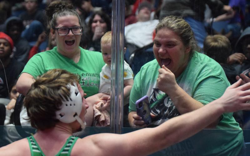 Moments after winning the state championship Saturday at the Macon Centerplex, Brady Simms celebrates with his sister Lacy Plontke (left) and baby Charlotte and his mother, Alicia Simms. (Photos by Scoggins)