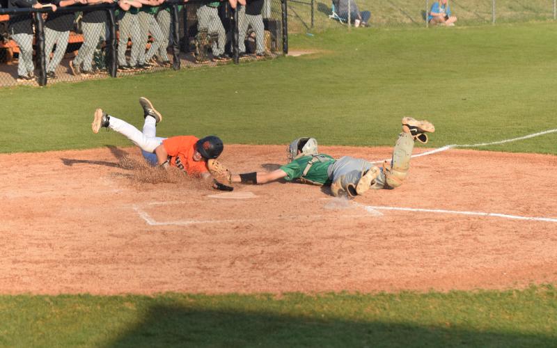Lions catcher Will Dodd tags a Hart County runner out just before his hand reaches the plate in Region 8AAA action Thursday in Hartwell. Franklin swept a doubleheader with the Bulldogs to finish a sweep of the three-game series. (Photos by Scoggins)