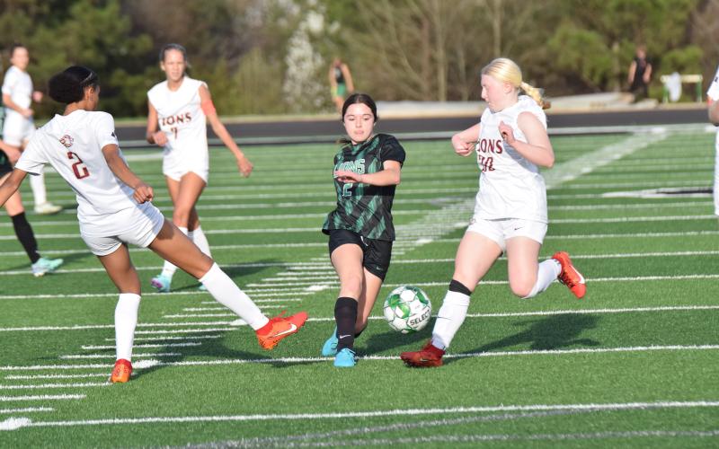 Lady Lion Brooke Davitt splits defenders during action against Hebron Christian Thursday at Jeff Davis Field at Ed Bryant Stadium. (Photos by Scoggins)