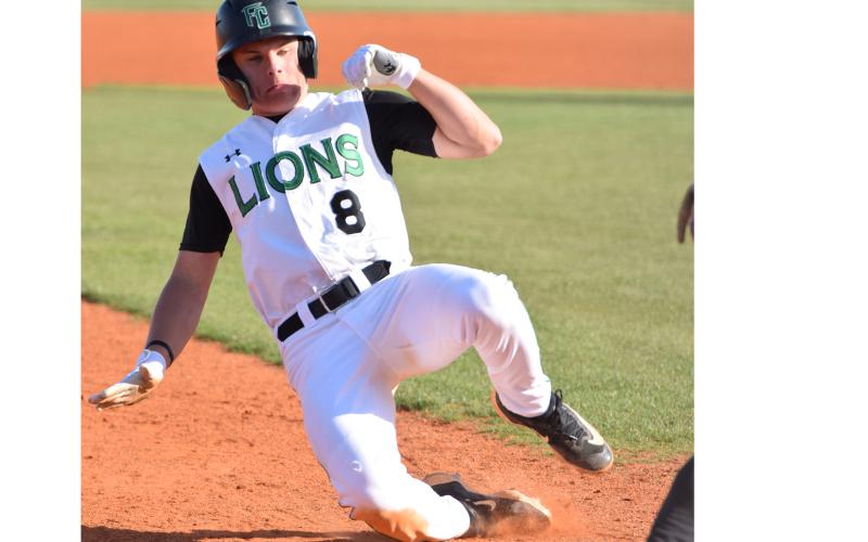 Will Cary slides while stealing third Tuesday in a first-round state playoff game against Douglass of Atlanta. (Photo by Scoggins)
