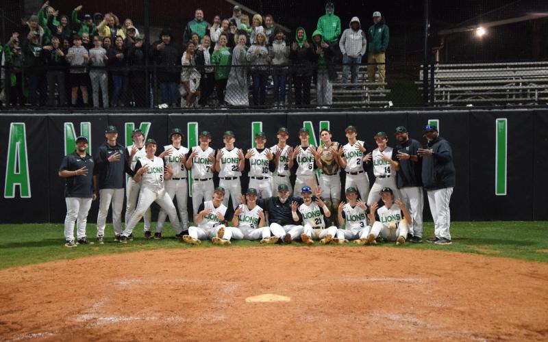 The Franklin County Lions celebrate after winning a fourth consecutive Region 8AAA baseball championship Friday in Carnesville. (Photo by Scoggins)