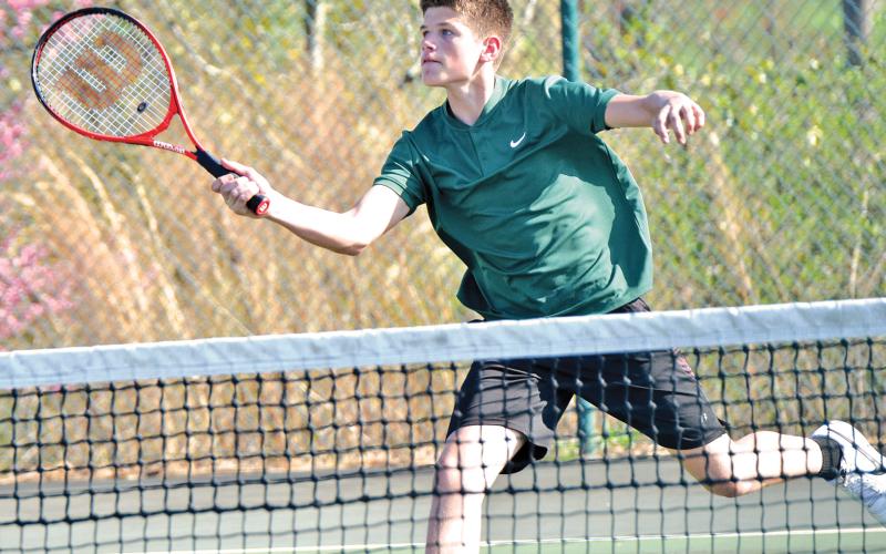 Martin Lunsford (above) returns a ball in tennis action earlier this season.