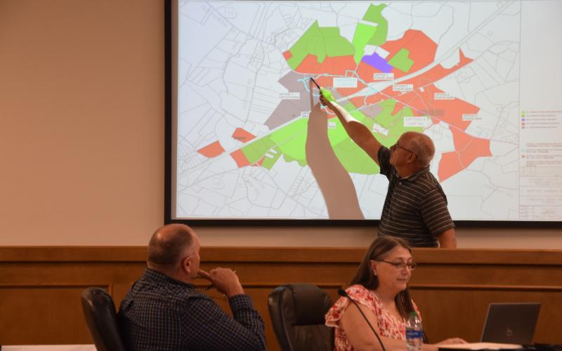County Engineer John Phillips explains options for sewer service to property along I-85 at Exit 160 during Tuesday night’s meeting of the Franklin County Board of Commissioners. (Photo by Scoggins)