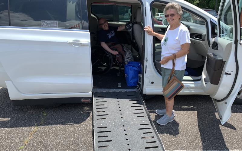 Wesley Bailey and his grandmother, Joyce Brooks, can get around much more easily now with the specially equipped van that his family recently purchased. (Photo by Eavenson)