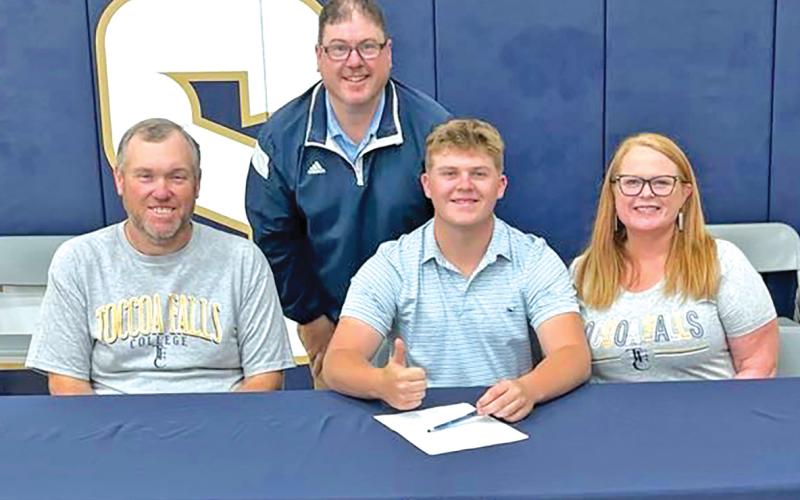D.J. Seymour (seated center) signed a golf scholarship with Toccoa Falls College Thursday. He was joined by parents Todd and Patsy Voyles and Toccoa Falls Coach David Beddingfield.