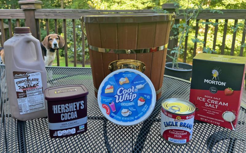 Sparky, the family’s Treeing Walker hound, spies the fixings for Tallulah chocolate on the NeSmiths’ backyard deck in Habersham County.  (Photo by Heather NeSmith)