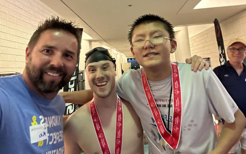 Carnesville Elementary School special education teacher Mike Schyck (left) takes a selfie with two swimmers at the Georgia Special Olympics held in May. Schyck volunteered at the event, held in Atlanta, and was assigned to the swimming competitions.