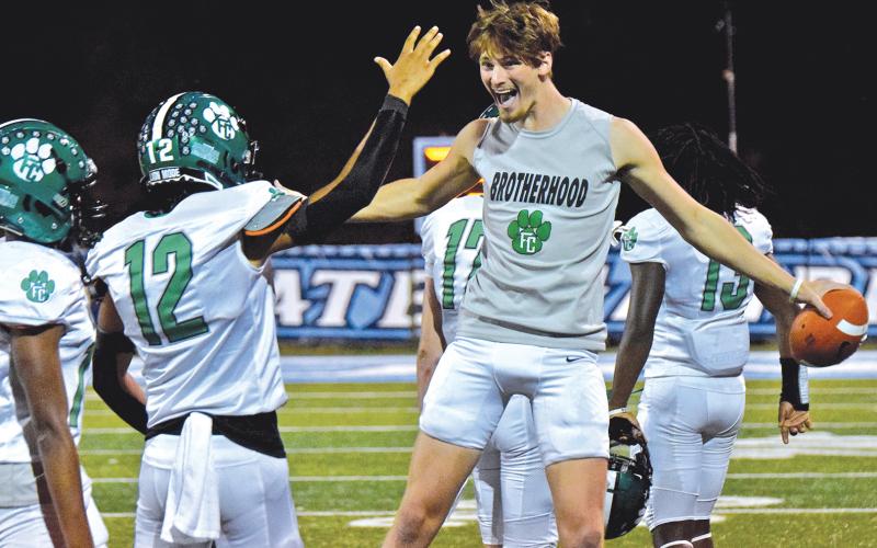 Blue Hart and teammate Jackson Burton (No. 12) celebrate Franklin County's 68-7 win over Johnson of Gainesville Friday. (Photo by Scoggins)