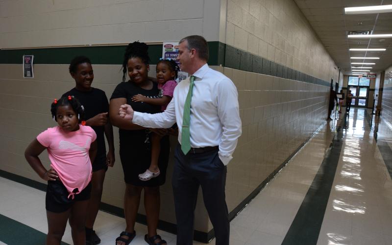 New Franklin County Middle School principal, Dr. David Cawthon, assists a family during the school’s open house on Tuesday. They are (from left) Paris Woulard, Xavier Ellis, Shamira Ellis and Zariah Woulard. (Photos by Eavenson)