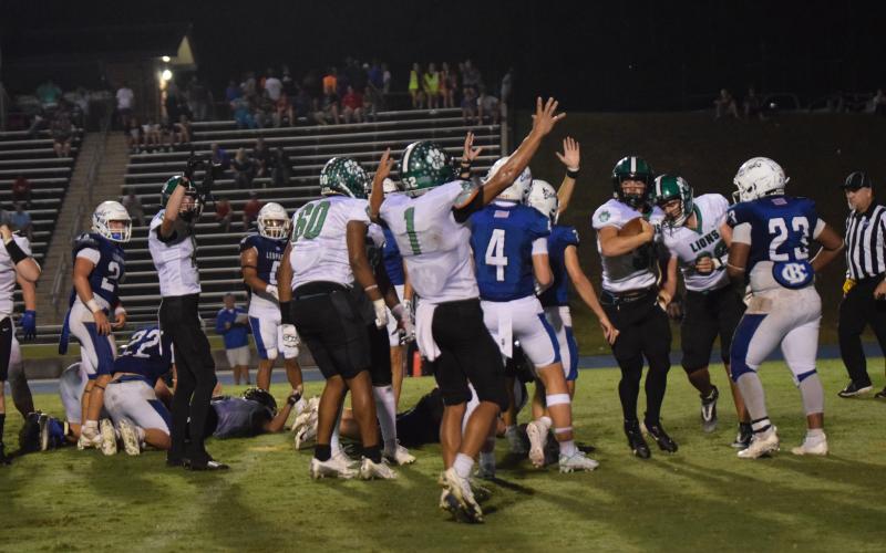 The Franklin County Lions celebrate quarterback Keyes Harbin’s (No. 33) touchdown with less than a minute to go that gave Franklin a 9-6 victory Friday over Banks County in Homer. (Photos by Scoggins)