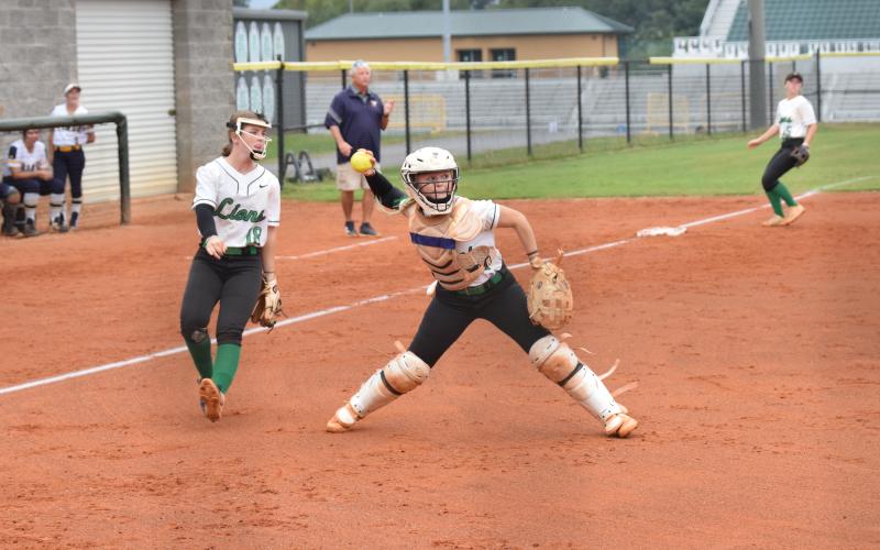 Catcher Keely Emmons prepares to make a throw to first after fielding a bunt against Prince Avenue Thursday in Carnesville. (Photo by Scoggins)
