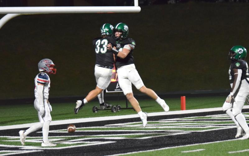 Keyes Harbin and Ramsey Fulbright (above) celebrate a touchdown Friday night during the Lions’ Homecoming game against West-Oak.