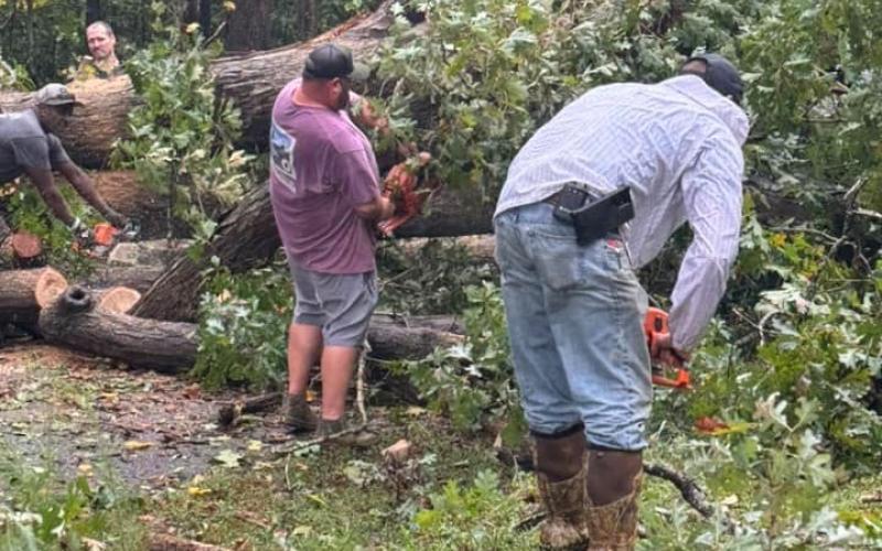 Jeremy “Bud” Fulghum and Michael Certain of Line Fire Department, with help from a Franklin County Detention Center work crew, clear a tree that fell over Burgess Road in Franklin County after the remnants of Hurricane Helene blew through the county Thursday night and Friday morning. (Photo courtesy of Ginger Fulghum)