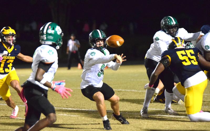Quarterback Keyes Harbin makes an option pitch to Gavin Wells in action Friday against Prince Avenue Christian in Bogart. (Photo by Scoggins)