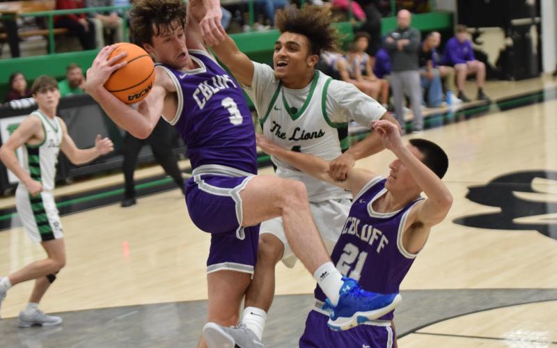Nava Ware (right) battles two Cherokee Bluff Bears for a rebound. (Photos by Scoggins)