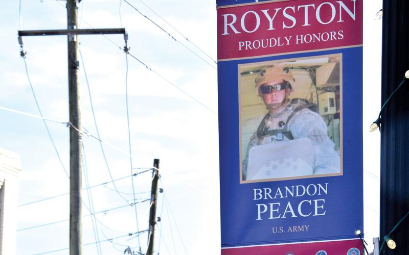 Banners bearing the faces of just some of those who have served in the U.S. armed forces are now on display in downtown Royston.