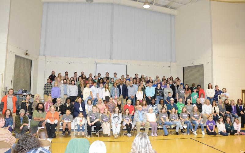 Current and former students attending Sunday’s Panther Walk at Royston Elementary School pose for a “class photo” after a ceremony in the gym. (Photo by Eavenson)