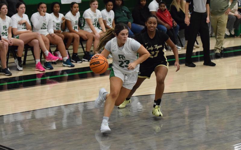 Bella Rosene drives to the basket against Commerce Thursday in the Lion’s Den. Rosene had 14 points in the game. (Photos by Scoggins)