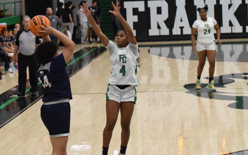 Nykhia Johnson pressures a East Jackson ball handler during Friday’s win in the Lion’s Den. Johnson made eight three-pointers in the game and finished with 27 points.