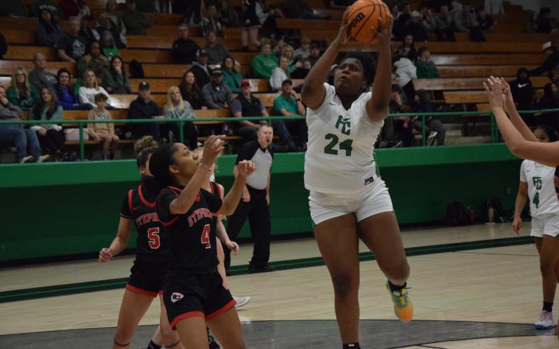 Ta’kiyah Merriett (right) collects a rebound.