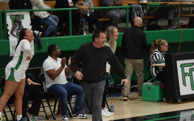Franklin County Lady Lion Head Coach Chad Bridges (right photo, left) and Assistant Coach Bailee Breedlove react to a good play by the team in the game against Hart County. (Photo by Scoggins)