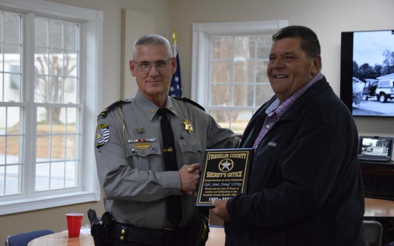 Sheriff Scott Andrews (left) presents a plaque of appreciation to Investigator Jimmy LeCroy, who retired Tuesday, after 38 years of service with the Franklin County Sheriff’s Office. (Photo by Scoggins)