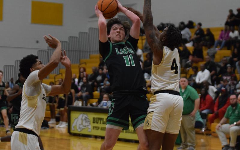 Bentley Huff (above) grabs a loose ball in action against Butler last week in the state quarterfinals against Butler in Augusta.