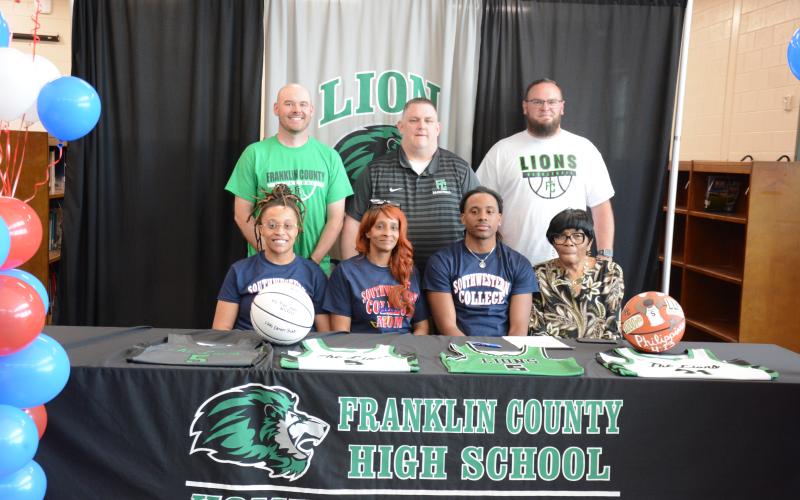Franklin County senior Frae’Quane Wilkins signed a scholarship Friday to play basketball at Southwestern Community College in Iowa. Taking part in the signing ceremony were (front, from left) sister Sherika Willis, mother Lashanda Willis, Wilkins, grandmother Chris Heard, (back) coaches Josh Smith, Head Coach Jason Shaver and Josh Bentley. (Photo by Eavenson)