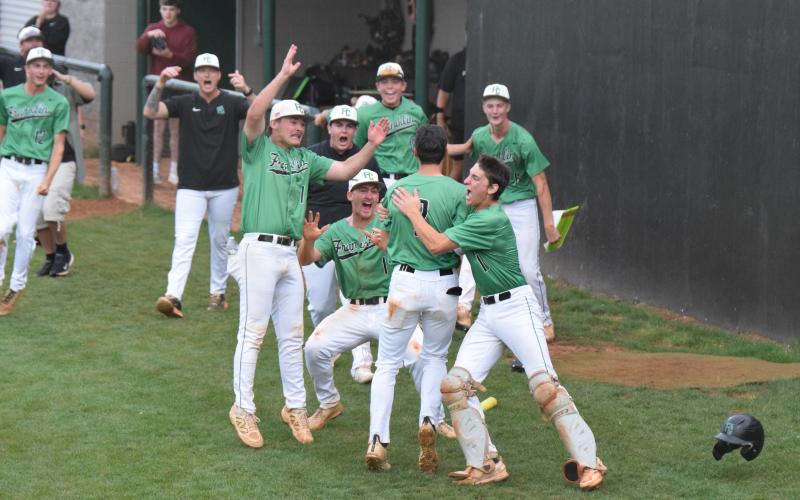 The Franklin County Lion baseball team defeated rival Stephens County last week to advance to the state semfinals. The team swarmed Ty Peeples (above right photo) after he scored the winning run in the first game against the Indians.