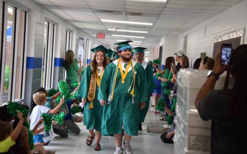 CARNESVILLE – Members of the Franklin County High School Class of 2025 will receive their diplomas Friday at Jeff Davis Field at Ed Bryant Stadium. Ceremonies are scheduled to begin at 8 p.m. In case of rain, the ceremony will be held at the Swails Center. Valedictorian Nathan Estrada (right) and Salutatorian Kayla Parker (left), pictured leading the class during the annual Lion Walk, will speak. For complete coverage of the class, see our annual Graduation Section inside. More photos from the Lion Walk are