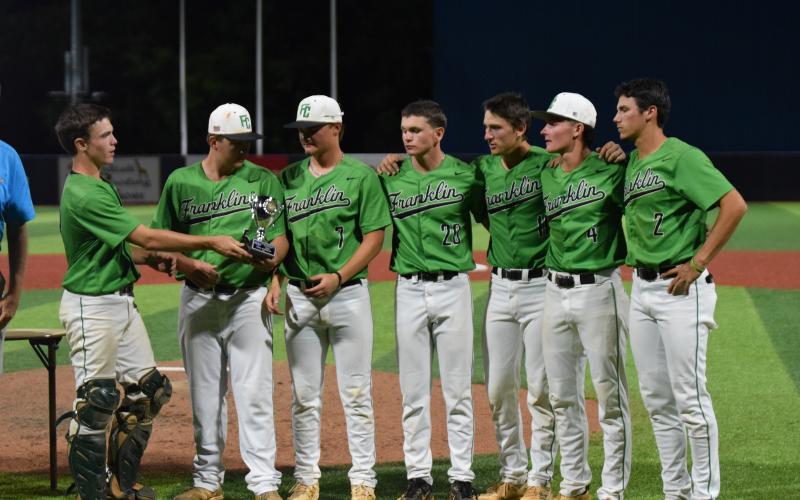 Franklin County Lion baseball seniors (from left) Colby Cape, Rowan Kennedy, Jackson Alexander, Parker Moorhead, Will Dodd, Cade Gibson and Ty Peeples accept the State Class AA Runner-up Trophy at AdventHealth Stadium in Rome May 21. (Photos by Scoggins)