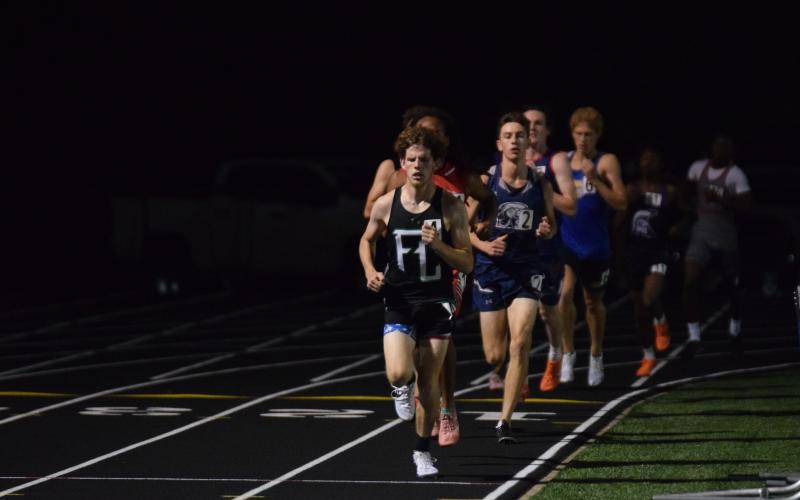 Franklin County track athletes Candler Stone, Macy Moore and Will Gipson (leading) won Georgia State Championships over the weekend at the state Class AA track meet in Commerce. Gipson grabbed first in the 3,200 meters.  (Photos by Scoggins)