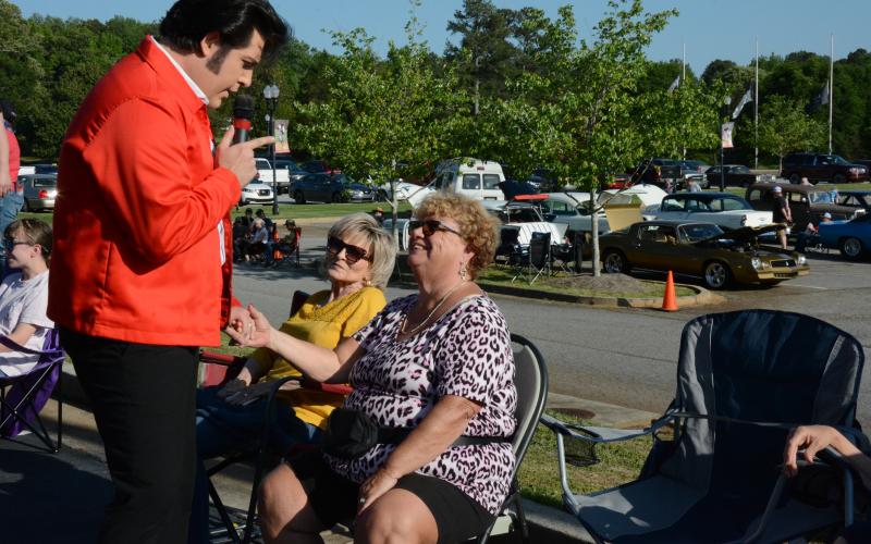 Austin Irby, a.k.a. Elvis, greets two of his biggest fans at Saturday’s Rhythm &amp; Rides event in Franklin Springs. Ann Reviere (left) and Judy Fields (right) said they are huge fans of Elvis and Irby.