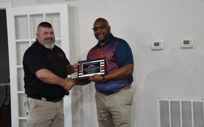 Retiring Royston Fire Chief Matt Elrod (left) was honored Tuesday with a reception at the Royston Depot. Mayor Keith Turman presented Elrod with a plaque commemorating his 33 years of service.