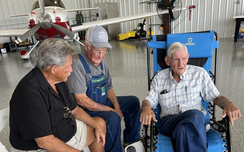 George Bennett (above photo, right) talks with State Rep. Alan Powell (left) and Tim Kennedy during a ceremony Sunday at the Franklin-Hart County Airport.