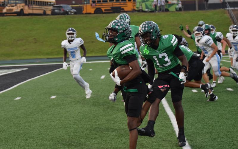 Gavin Wells celebrates with teammate Jeremiah Mayfield on his way to the end zone for a touchdown.