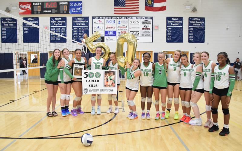 ELBERTON – Members of the Franklin County Lady Lion volleyball team took time out during a game Tuesday against Rabun County in Elberton to congratulate junior Avery Burton for her 500th career kill. The team went on to defeat Rabun County and Elbert County. For complete details, see Page 11. (Photo by Shane Scoggins)