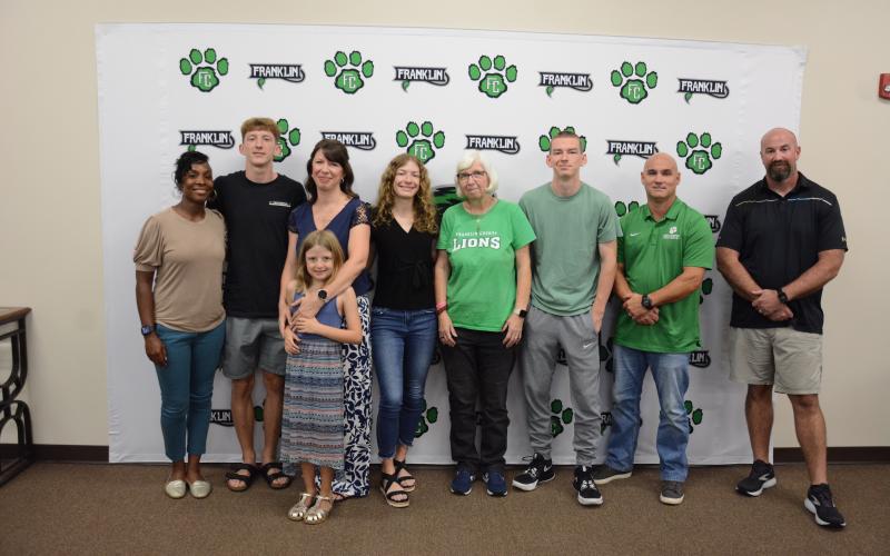 Attending the Franklin County Board of Education meeting Thursday for the naming and dedication of the system’s cross-country course as the Bill “Woody” Woods Pridelands Course are (from left) FCHS Track Coach Ann Bowman, Cole Woods, Heather Woods, Lelia Woods, Gracie Woods, Donna Barnes, Robbie Woods, Jared Hightower and FCHS Cross-Country Coach Clint Tanner. (Photo by Charlie Eavenson)