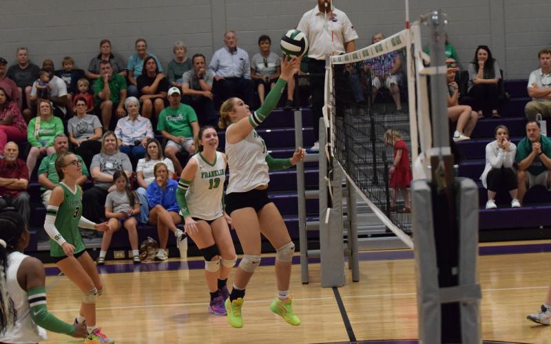 Callie Frady pokes the ball over the net in action against East Hall Thursday at South Franklin Elementary School. (Photos by Shane Scoggins)