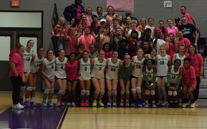 The Franklin County Lady Lions volleyball team celebrate with the Rude Crew after sweeping Stephens County in the first round of the Region 8AA tournament Tuesday at South Franklin Elementary School. The win secured a state playoff berth for FCHS for the first time in school history. (Photo by Shane Scoggins)