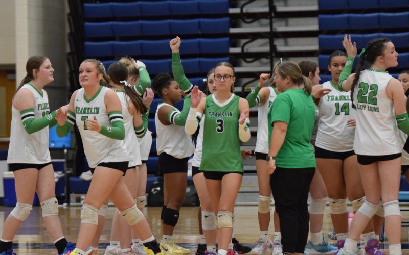 Enslee Stowers (No. 3) and Callie Frady (No. 7) lead the Lady Lions out of a timeout during Saturday’s state semifinal match against Ringgold in Marietta.