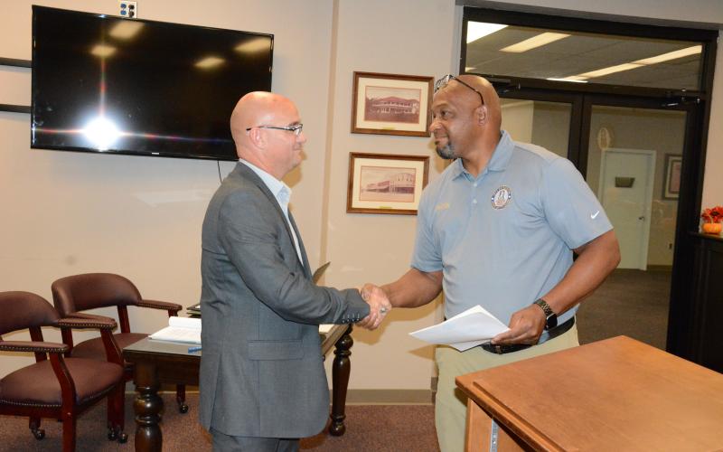 Royston Mayor Keith Turman (right) shakes hands with new Council Member Jared Hightower Tuesday after a swearing-in ceremony at Royston City Hall. Hightower then joined the council for its regular monthly meeting. (Photo by Charlie Eavenson)