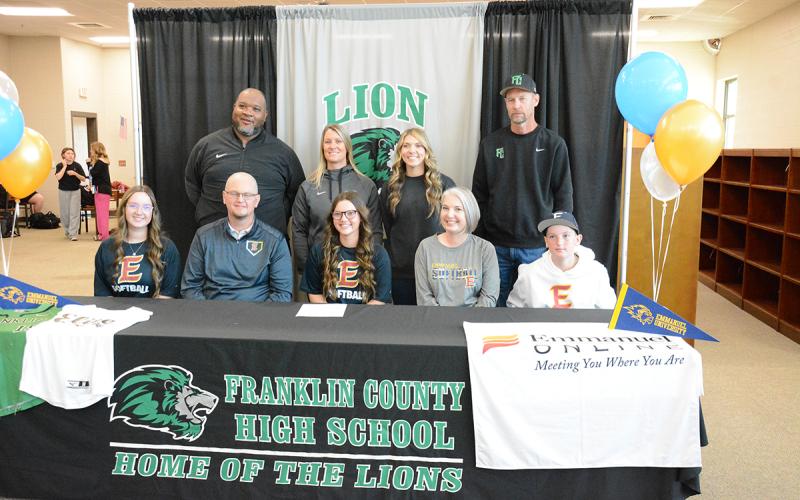Hayden McGee signed her scholarship to play softball for Emmanuel University while her coaches and family looked on. Those in attendance were (seated, from left) sister Ava McGee, father Bruce McGee, Hayden, mother Laura McGee, brother Brooks McGee, (back) Coach Demond Rivers, head coach Cherokee Bell, Coach Kendsey Chappelear and Coach Tim Cawthon.