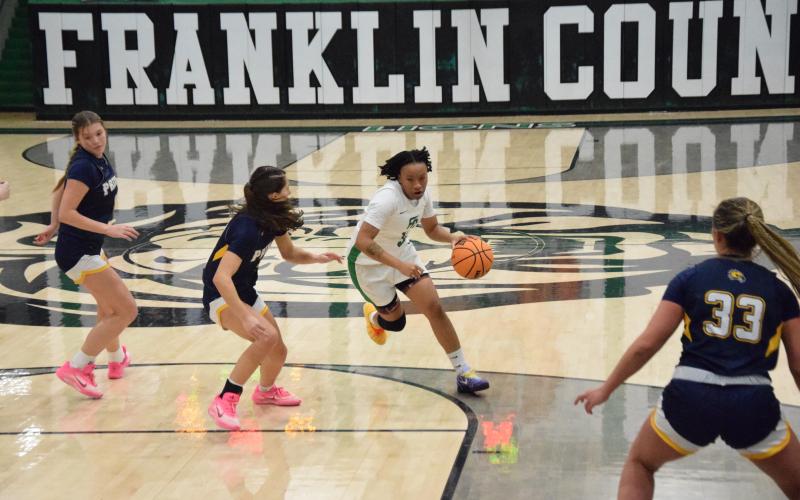Ta’Kiaha Winkfield drives past a Prince Avenue defender in Friday’s Franklin County win over the Lady Wolverines. The game was Winkfield’s season debut after missing the start of the season due to injury. (Photos by Shane Scoggins)