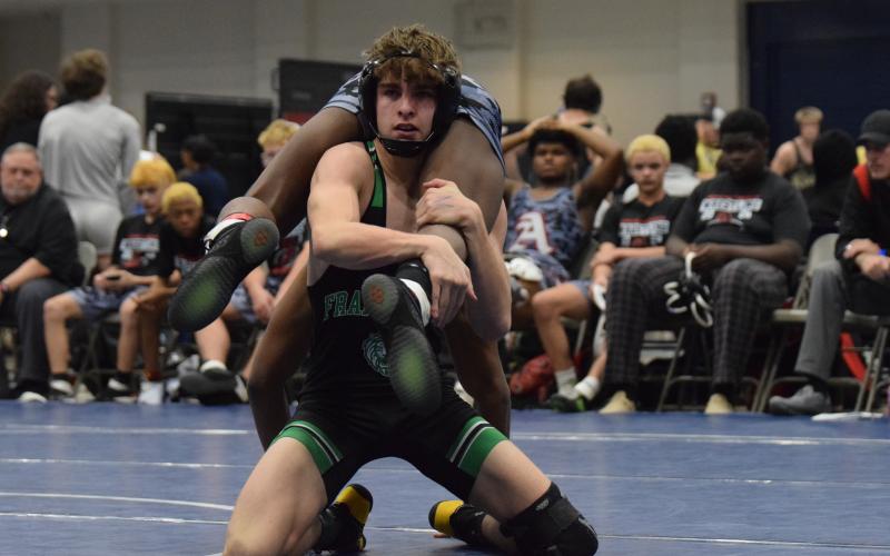 Jaxon Norwood works to finish a takedown against an Appling County opponent Friday in the State Duals Championship at East Jackson High School. (Photo by Shane Scoggins)